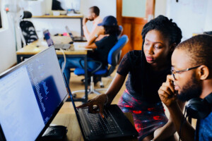 Team viewing work together on computer