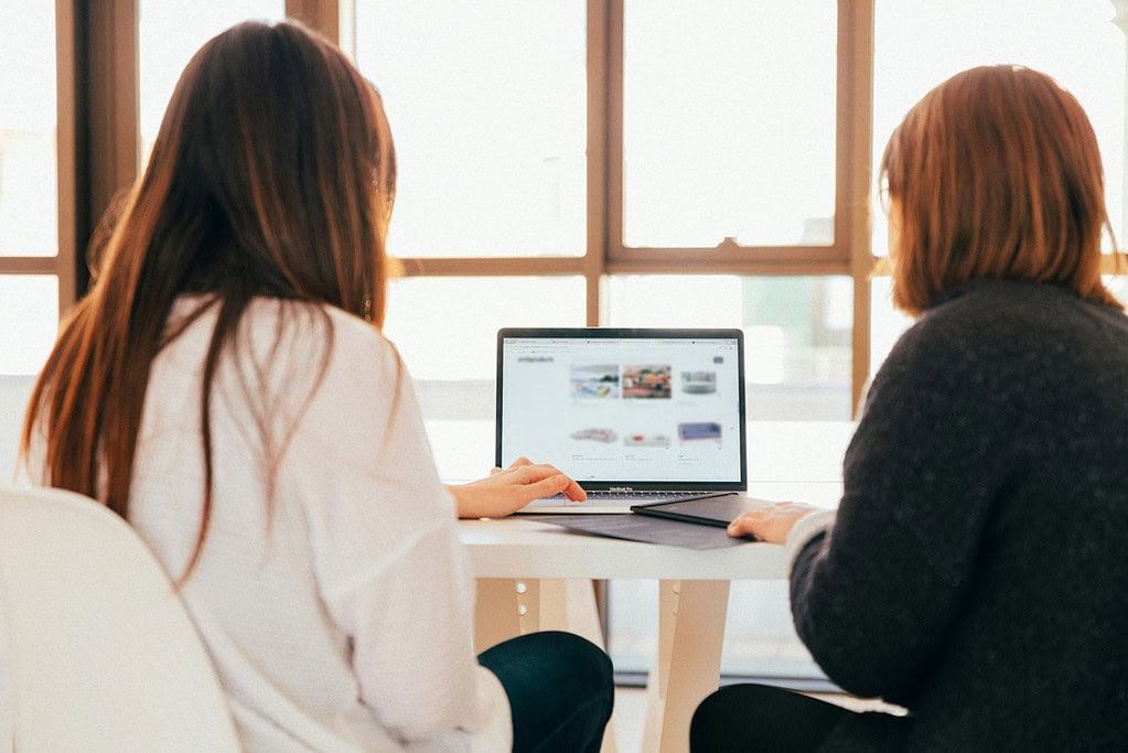 two women at a school reviewing a website design