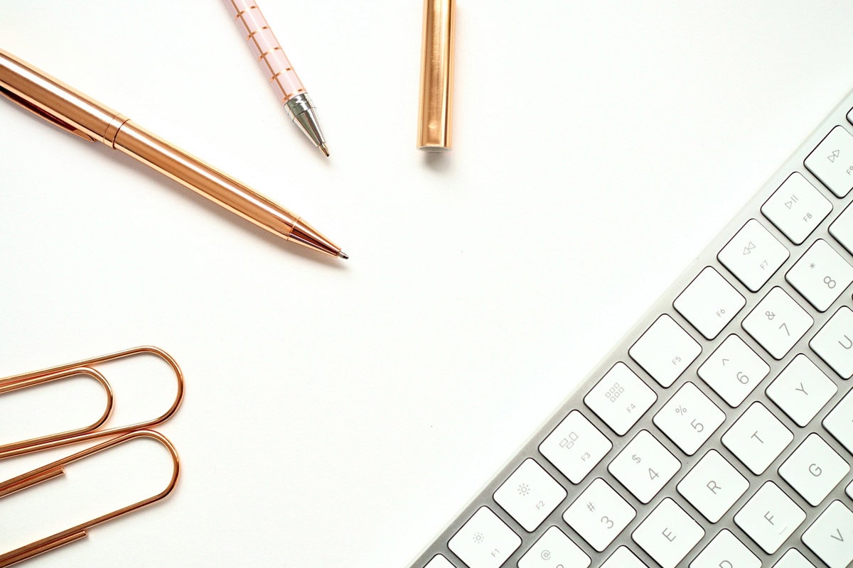 Overhead of pencils, pens and a keyboard