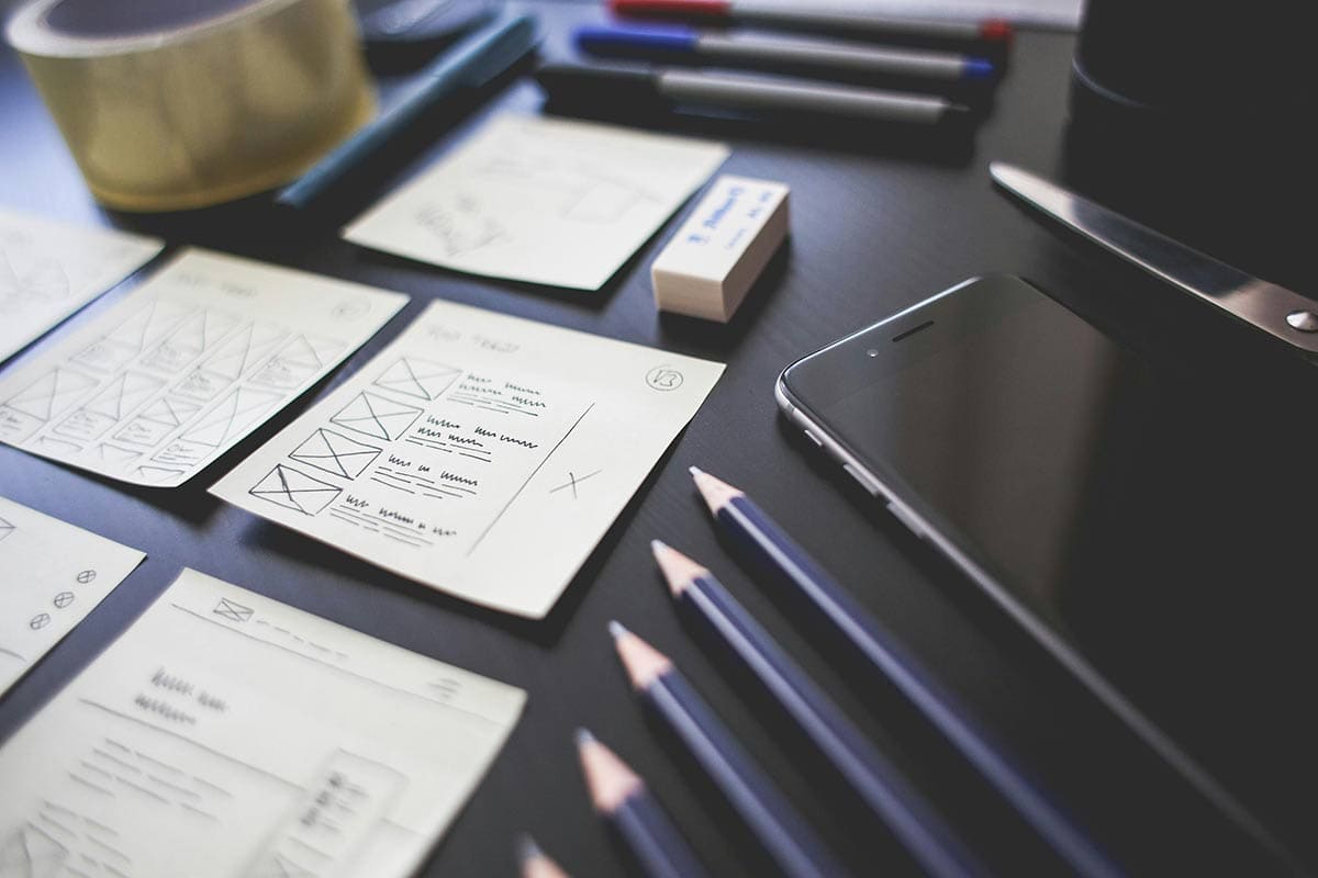 Post-it notes and pencils on a desk outlining web design