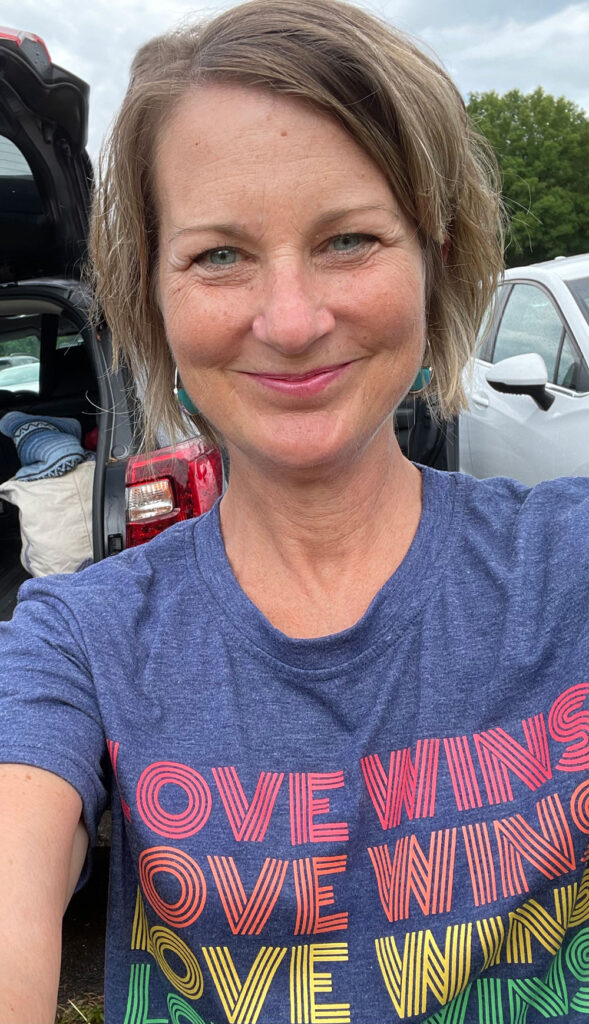 Tara Claeys wearing a shirt that says Love Wins